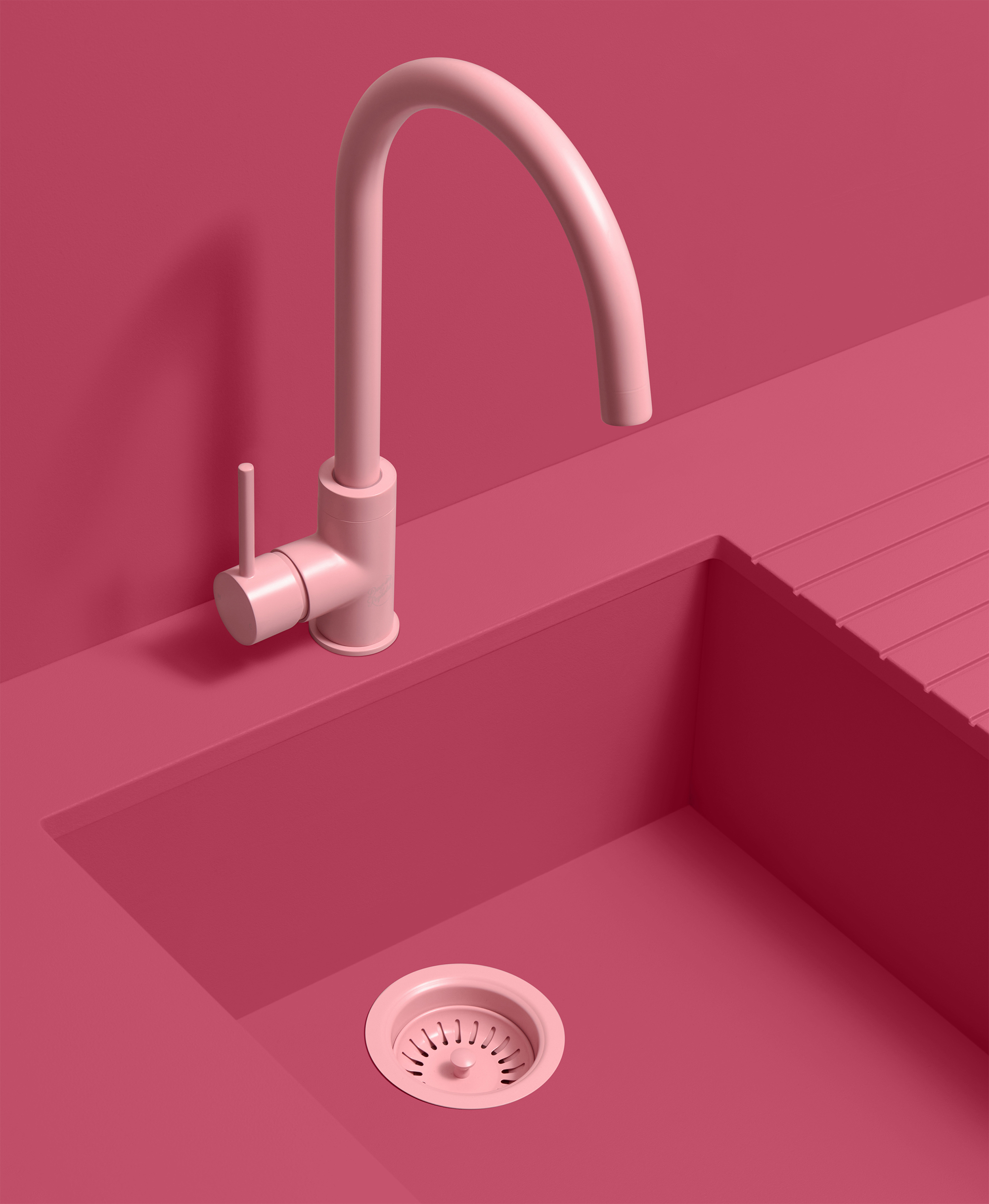 a light pink kitchen tap on a pink backdrop