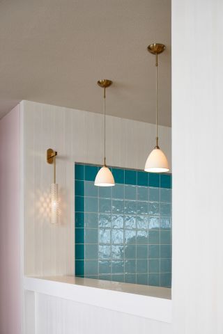 Blue tiles on wall and hanging lights