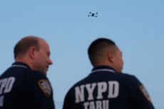 NYPD officers watch a drone in Queens, New York City. 