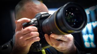 An attendee uses the Nikon D5 DSLR camera at the Nikon booth at CES 2016 at the Las Vegas Convention Center on January 6, 2016 in Las Vegas, Nevada. The camera is schedule to be available in March at cost USD 6500. 
