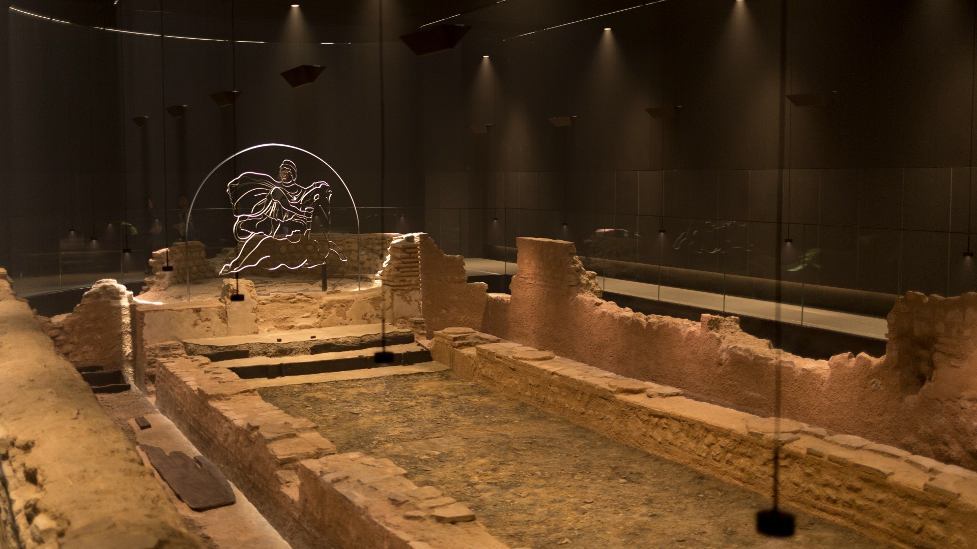 Atmospheric lighting helps display the reconstructed mid-3rd century Roman Mithraeum also known as the Temple of Mithras, Walbrook where bull-sacrifice was practised, now beneath Bloomberg's new European headquarters and open to the public, on 26th November 2017, in the City of London, England.