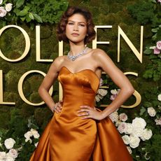 Zendaya wears a rust Louis Vuitton gown and matching court shoes at the 2025 Golden Globes