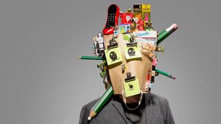 Art direction: Man with bag on his head, stationary supplies are poking out of the bag