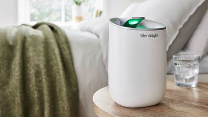 The Silentnight dehumidifier sat on a bedside table next to a glass of water