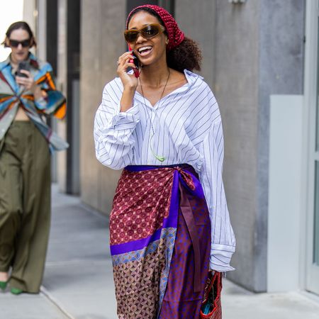 Woman in a button-down and sarong skirt