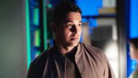 Nick Torres looking concerned in the NCIS office. 