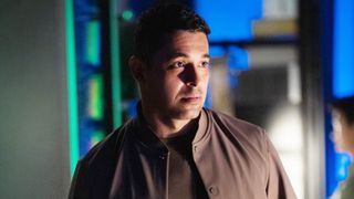 Nick Torres looking concerned in the NCIS office. 