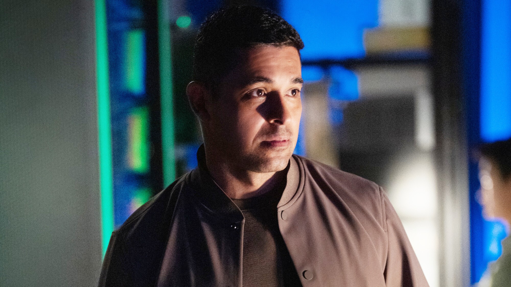Nick Torres looking concerned in the NCIS office. 