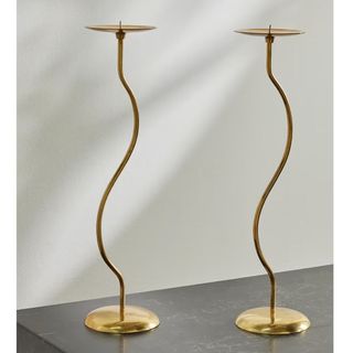 couple of brass curved candlesticks
