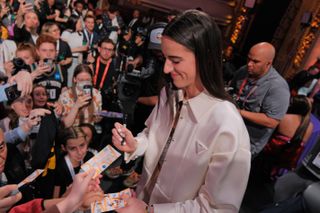 Caitlin Clark signs autographs at the WNBA draft in March