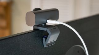 Logitech MX Brio webcam on top of a monitor seen from behind
