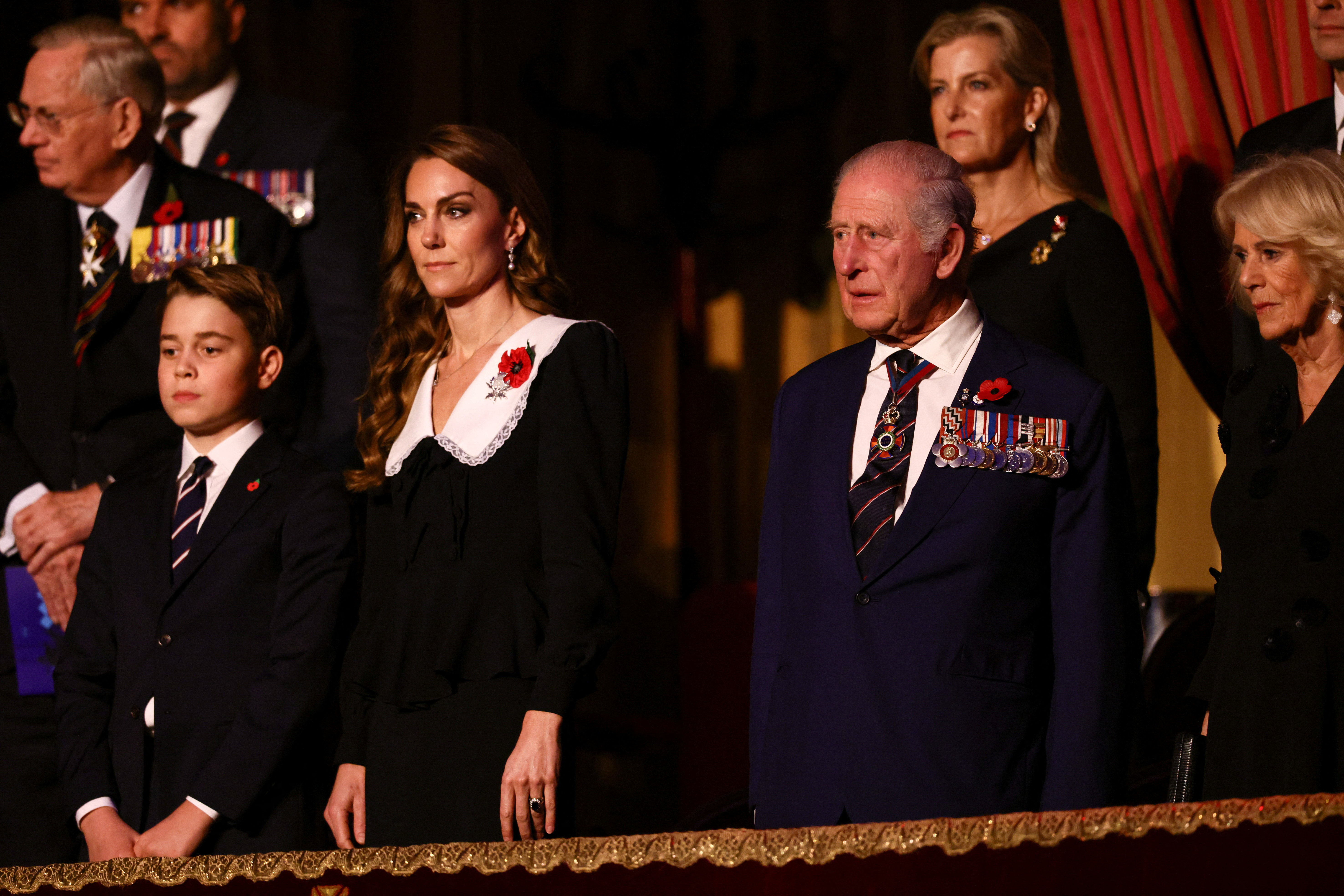Prince George standing next to Princess Kate, King Charles and Queen Camilla at the Festival of Remembrance