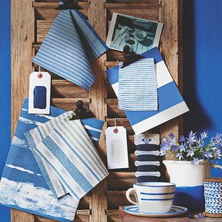 blue wall with wooden frame wall hanger with napkins
