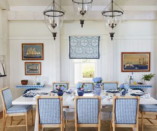 dining room with white walls and blue gingham chairs and white table