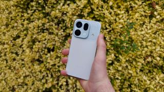 A blue Oppo Find X10 phone against a background of yellow leaves