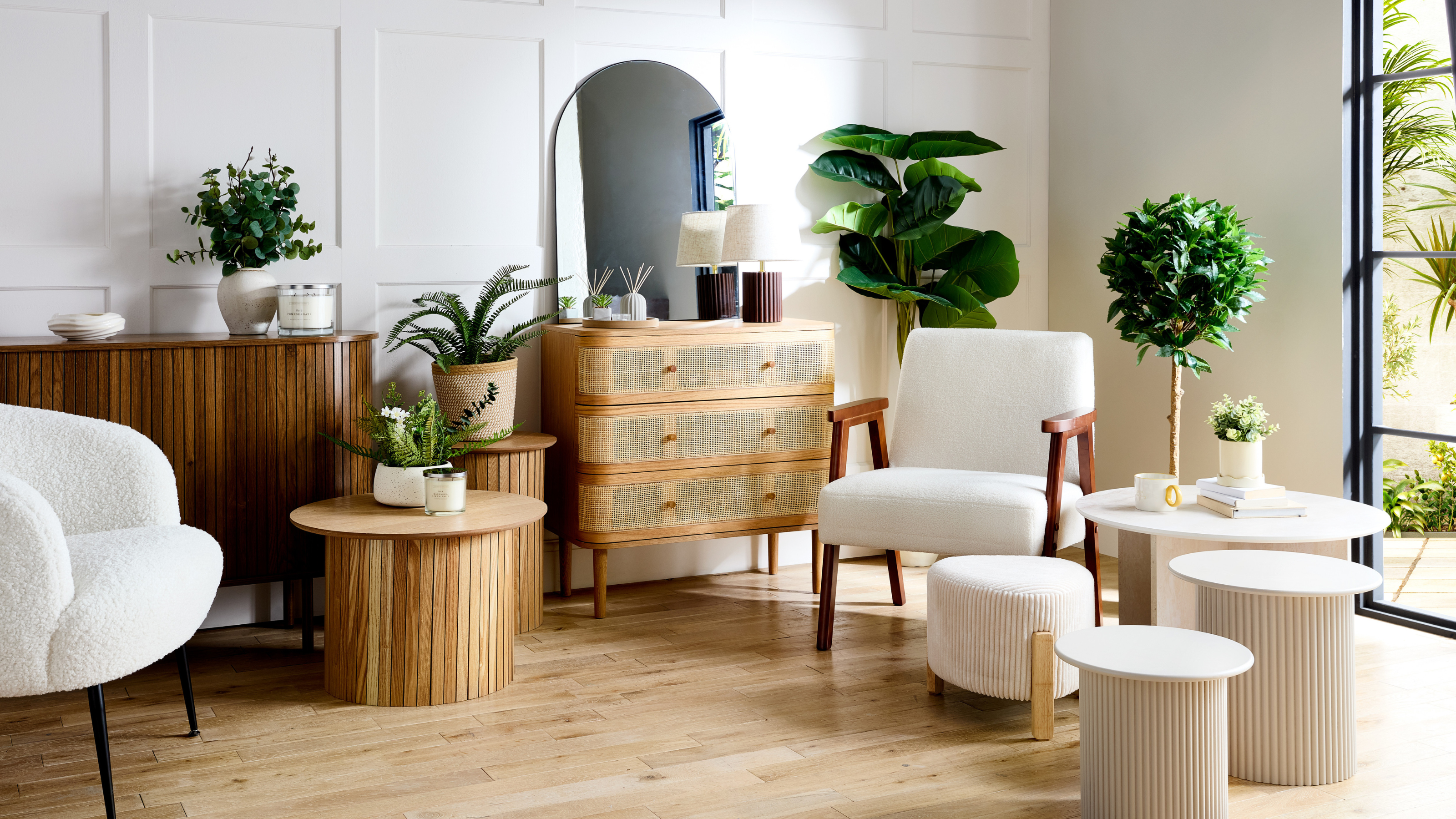 Modern, light living room with wood finishes and cream furniture.