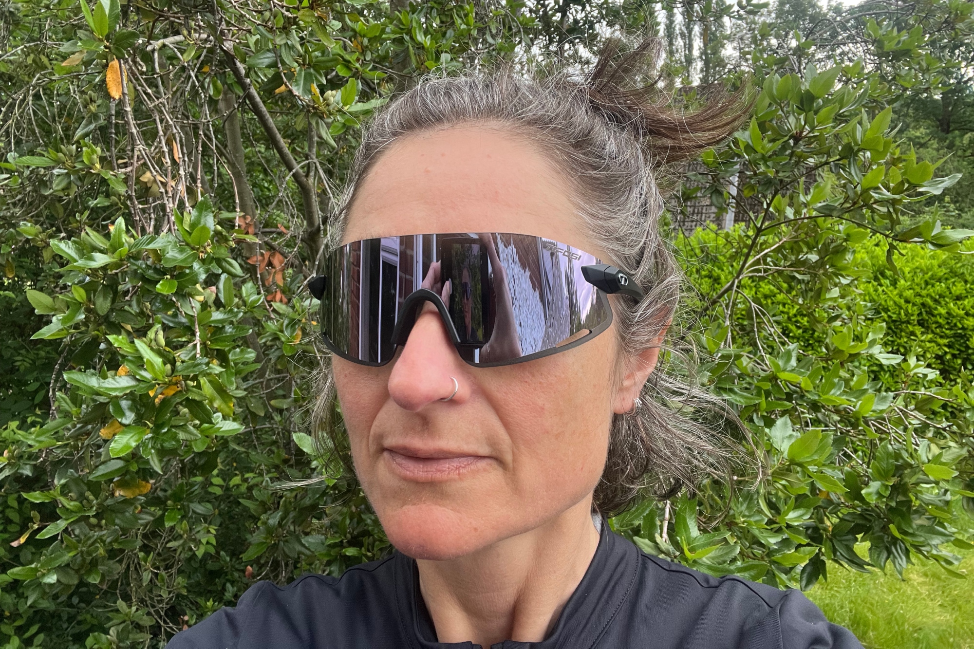 Hannah Bussey with the Tifosi Vogel XC Sunglasses on with trees behind her
