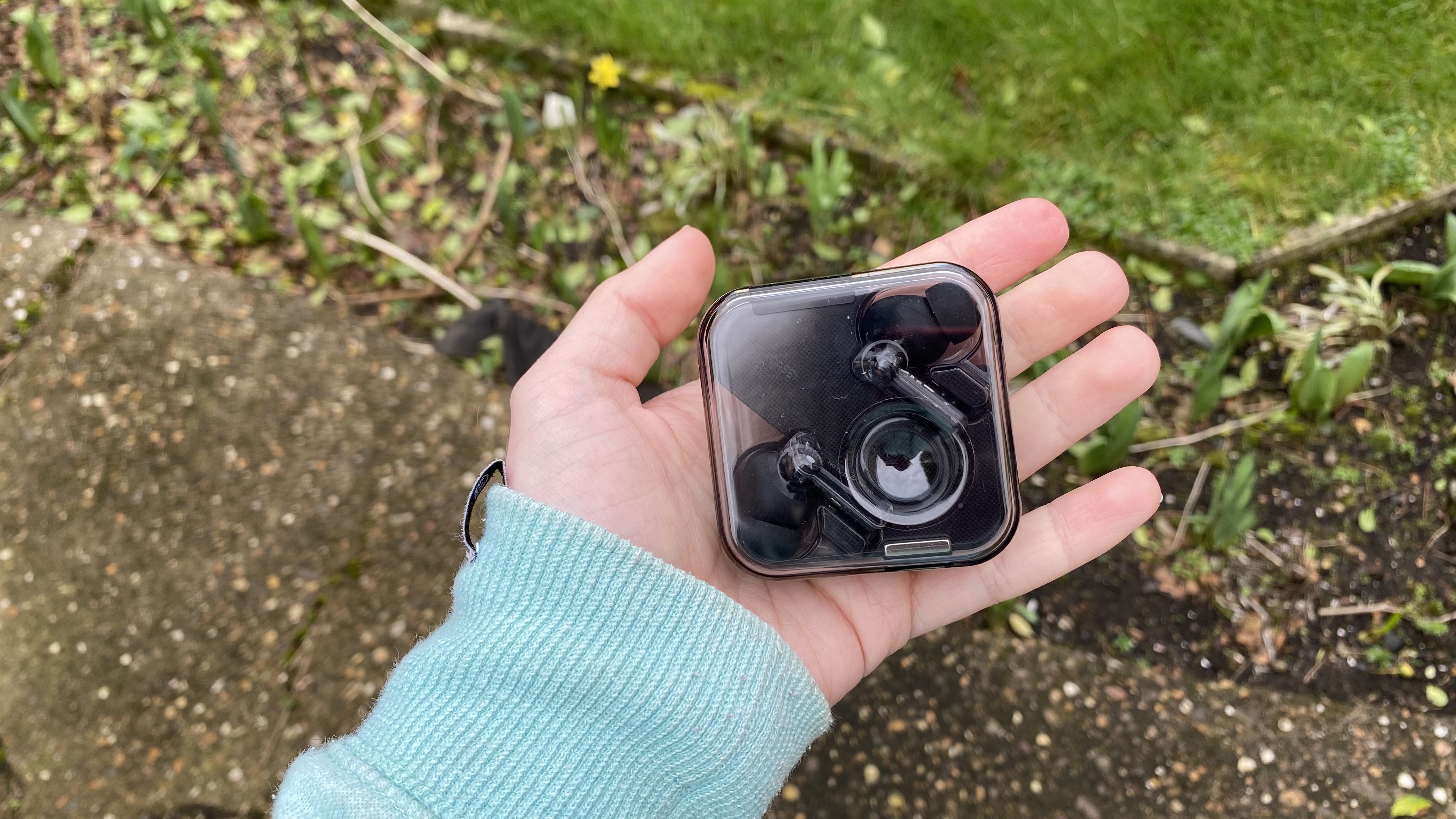 the nothing ear 1 true wireless earbuds in their charging case