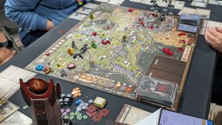 A full setup for Fate of the Fellowship with cards, tokens, and pieces all laid out