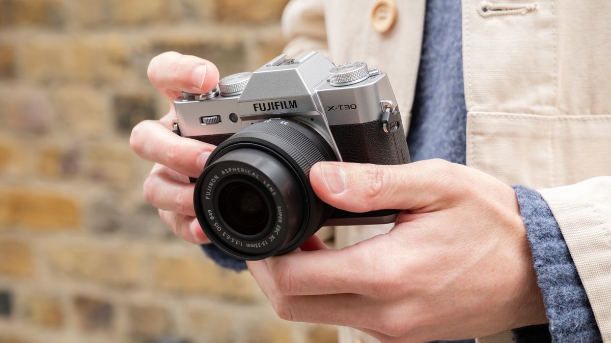 Fujifilm X-T30 III camera held in a pair of hands