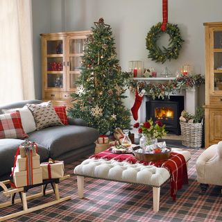 living room with grey wall grey sofa and christmas tree