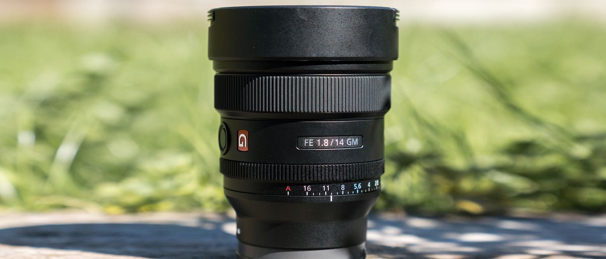 Front view of the lens set against green grass