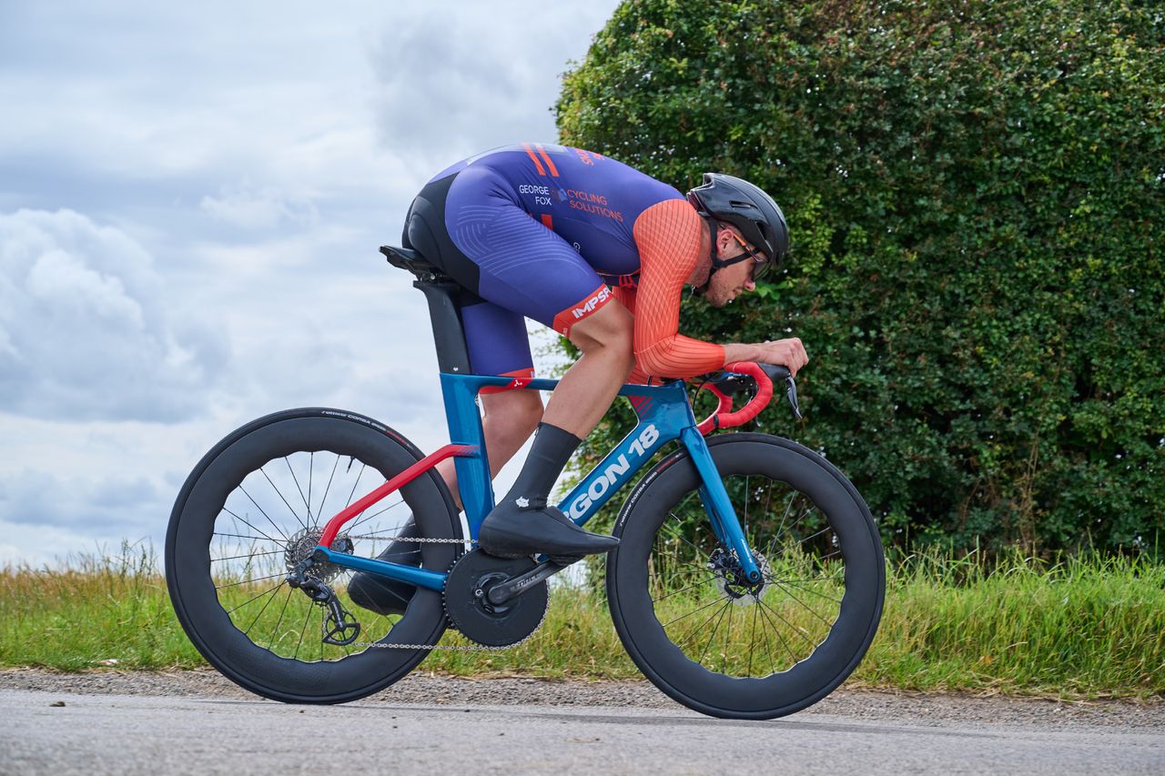 George Fox riding in an aero position on a road bike