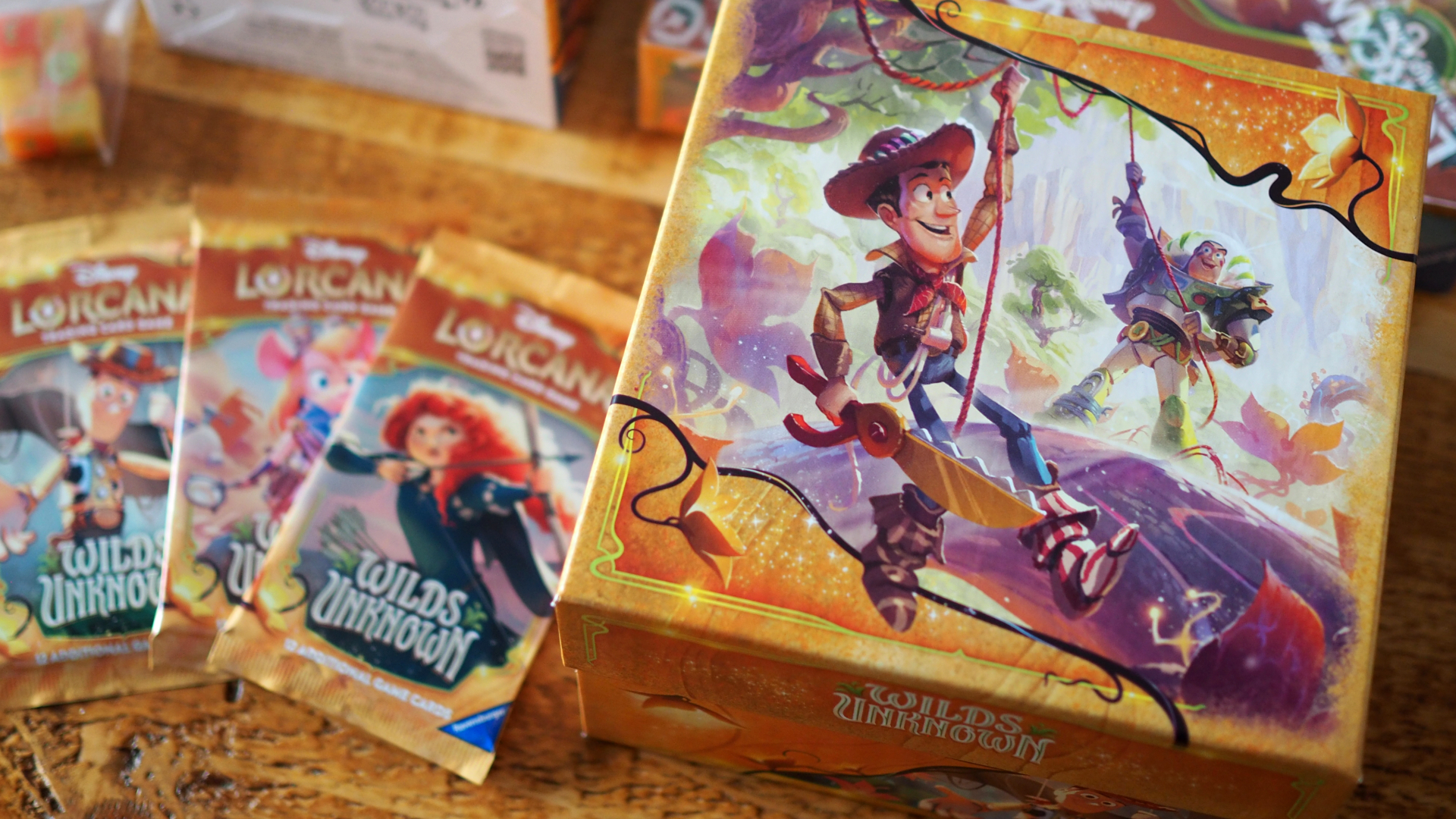 The Illumineer's Trove for Wilds Unknown alongside some booster packs on a wooden table