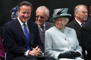 David Cameron and the Queen sat next to each other