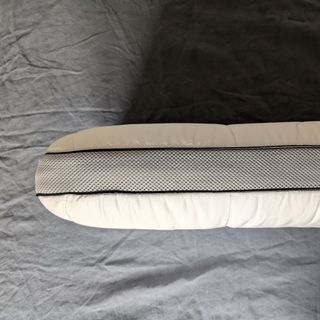 The Panda Hybrid Bamboo Pillow being tested on a grey linen duvet cover