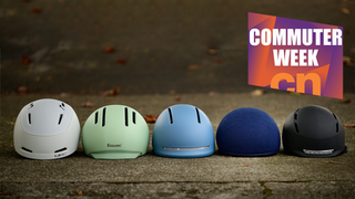 A collection of commuter helmets, overlaid with the commuter week badge