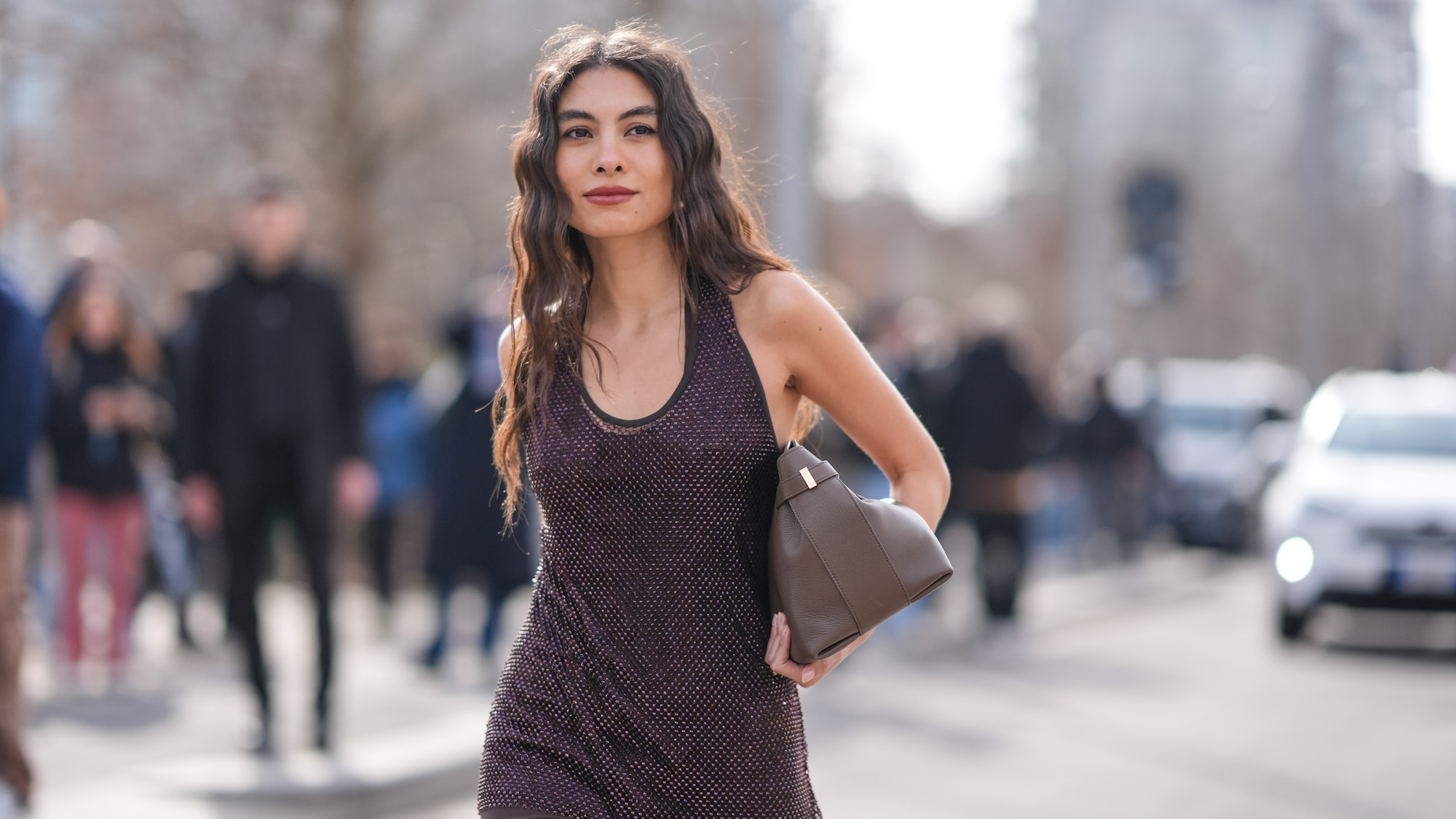 woman with mermaid wave hair and vest top