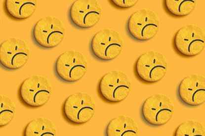 sad emoji faces on yellow crackers with yellow background