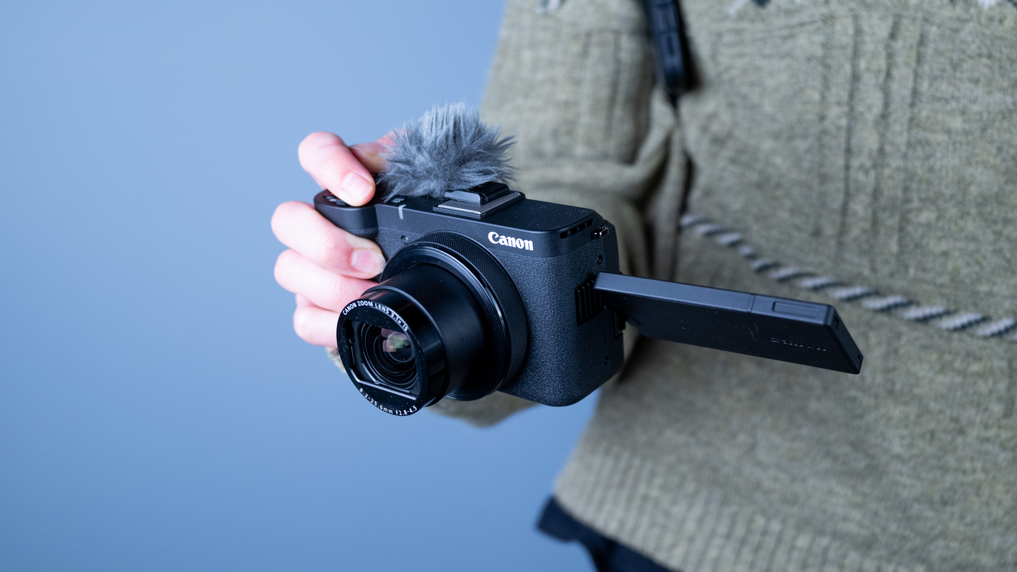 A black Canon PowerShot V1 compact vlogging camera