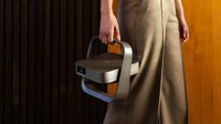Xgimi Elfin Flip 4K projector being carried around by its handle