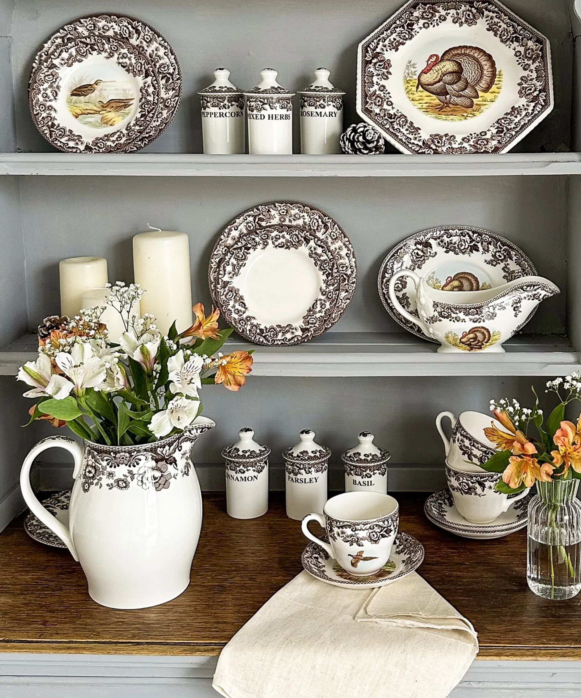 Brown floral Spode tableware displayed on grey shelving unit