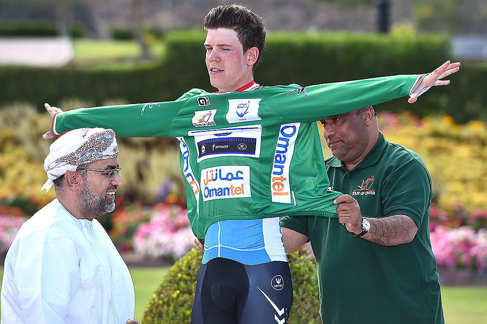 Bob Jungels puts on the green jersey after stage 1 in Oman.