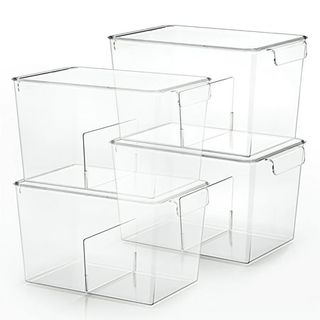 Four clear plastic storage bins with lids stacked in twos