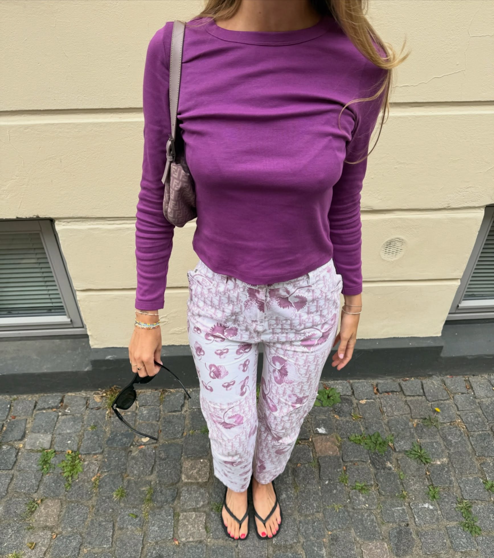 An image of @julietbrabander wearing a purple top from sustainable fashion brand Flore Flore.