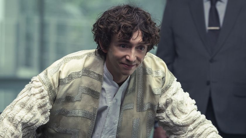 Boy Kavalier smiling and leaning on table during meeting with Weyland Yutani in Alien: Earth &quot;The Fly&quot;