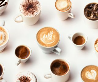 cappuccino cup and lots of other coffee cups on a white surface