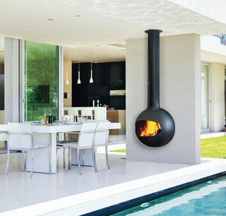 Outdoor fireplace attached to the wall with seating and a pool