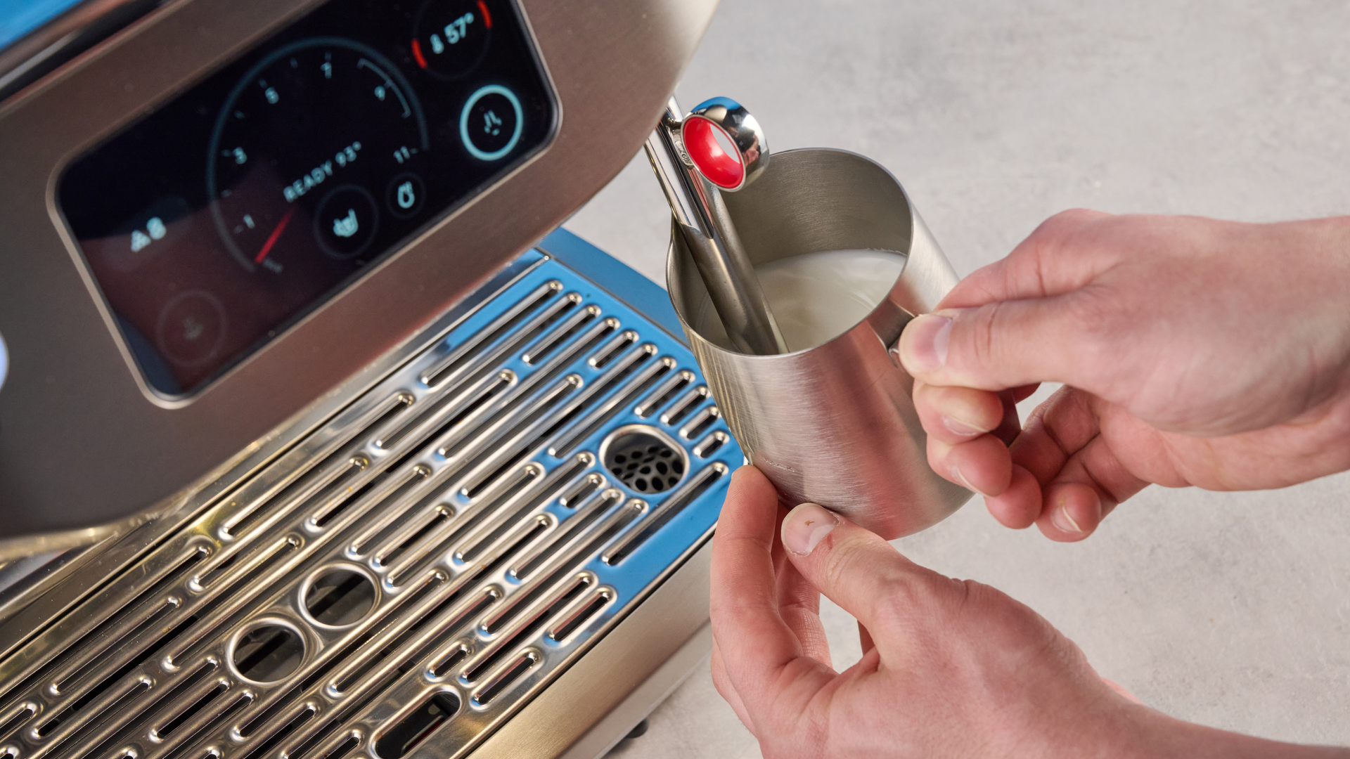 the breville oracle dual boiler / sage oracle dual boiler in stainless steel, showing its touchscreen, steam wand, built in grinder, and espresso shots