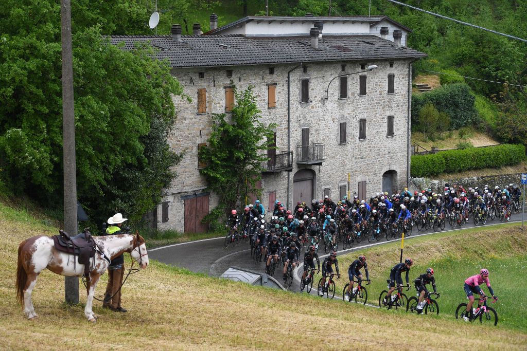 SESTOLA ITALY MAY 11 Filippo Ganna of Italy and Team INEOS Grenadiers Pink Leader Jersey leads The Peloton during the 104th Giro dItalia 2021 Stage 4 a 187km stage from Piacenza to Sestola 1020m Rain Fans Public Horses Landscape girodiitalia Giro UCIworldtour on May 11 2021 in Sestola Italy Photo by Tim de WaeleGetty Images