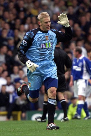 Peter Schmeichel reacts after scoring for Aston Villa against Everton