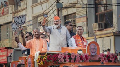 Prime Minister Narendra Modi greets supporters at a roadshow on April 06, 2024 in Ghaziabad, Uttar Pradesh, India