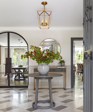 entryway with table and vase of flowers