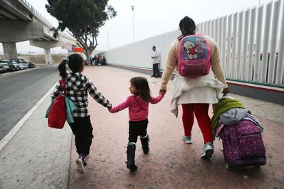 A migrant mother and her two small children.