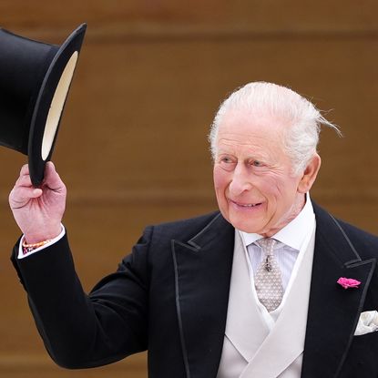 King Charles tipping his top hat