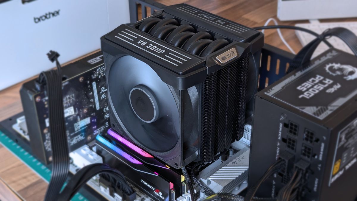 Cooler Master V8 ACE 3DHP CPU cooler installed inside a test bench with running fans above RGB RAM